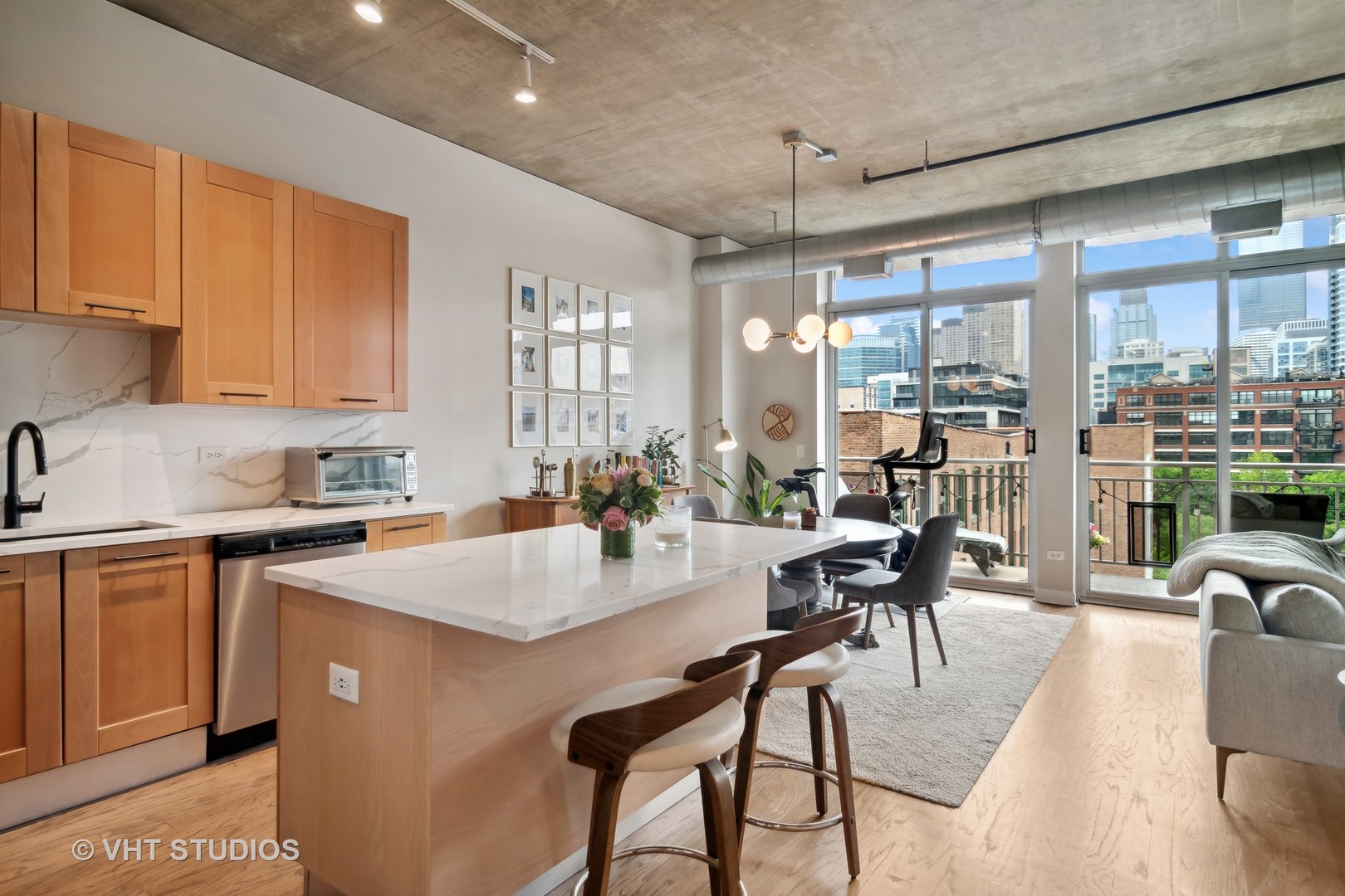 Undisclosed Address Chicago, IL 60607 - Photo 12 of 22 a open kitchen with stainless steel appliances granite countertop a stove a refrigerator a kitchen island a table and chairs