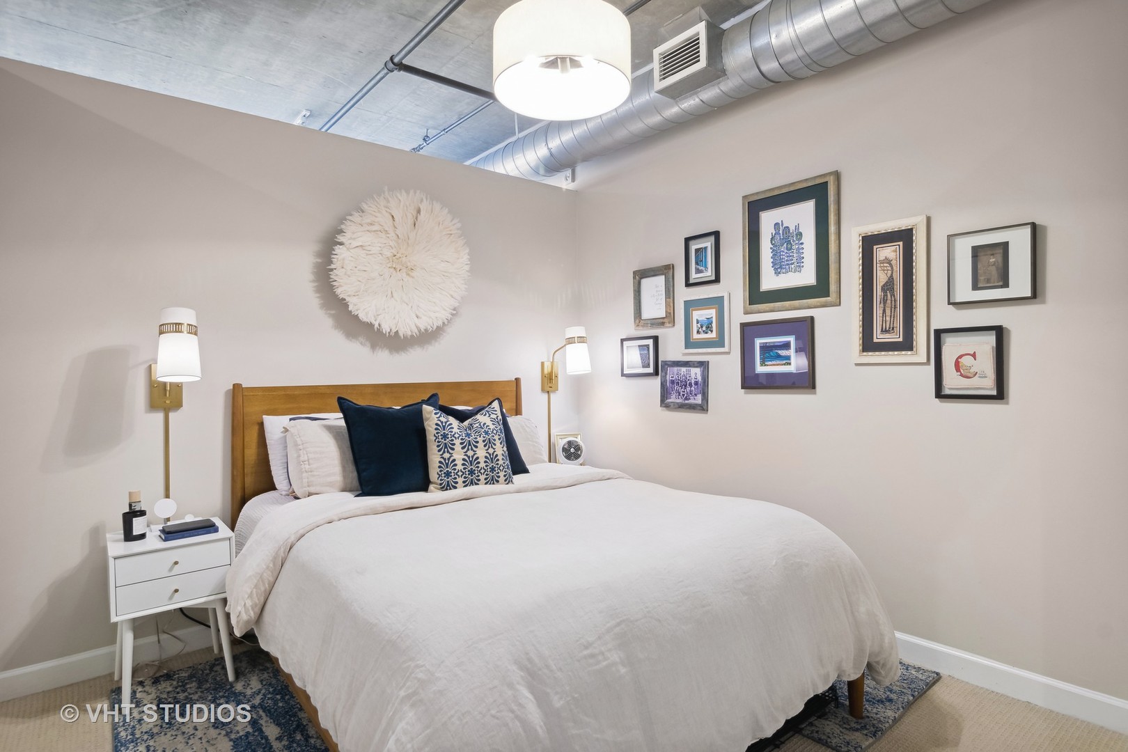 Undisclosed Address Chicago, IL 60607 - Photo 16 of 22 a bedroom with bed and a chandelier
