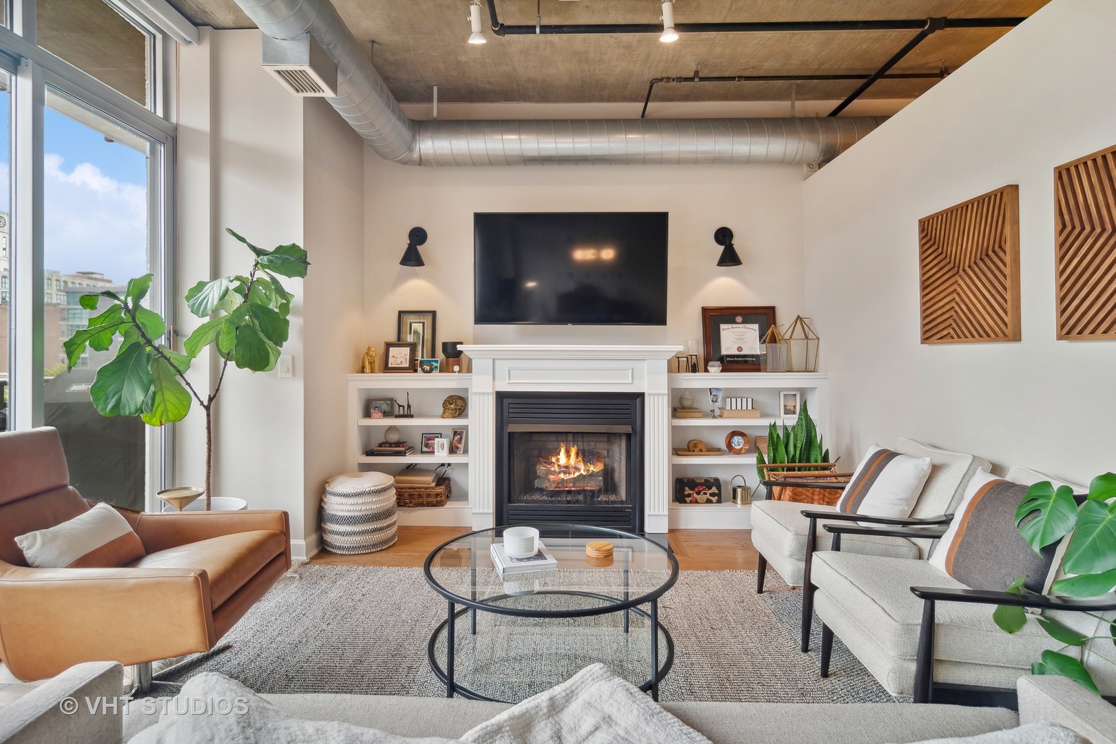 Undisclosed Address Chicago, IL 60607 - Photo 4 of 22 a living room with furniture a flat screen tv and a fireplace