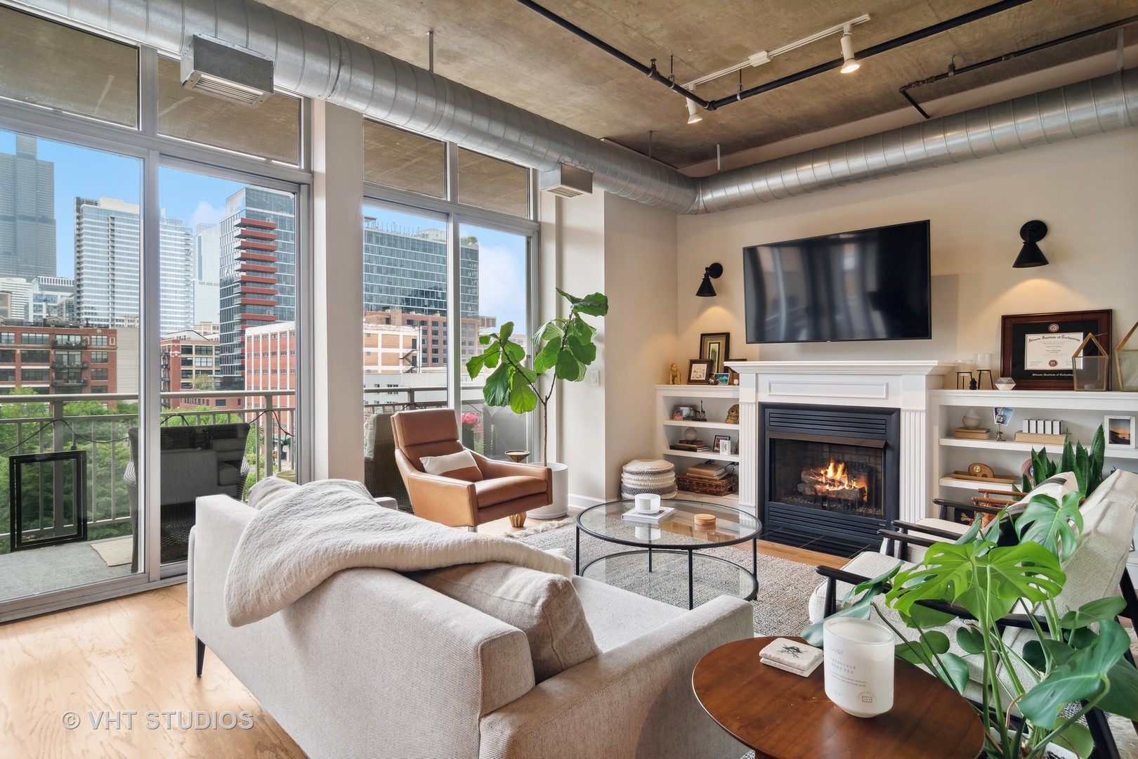 Undisclosed Address Chicago, IL 60607 - Photo 5 of 22 a living room with furniture a flat screen tv and a fireplace