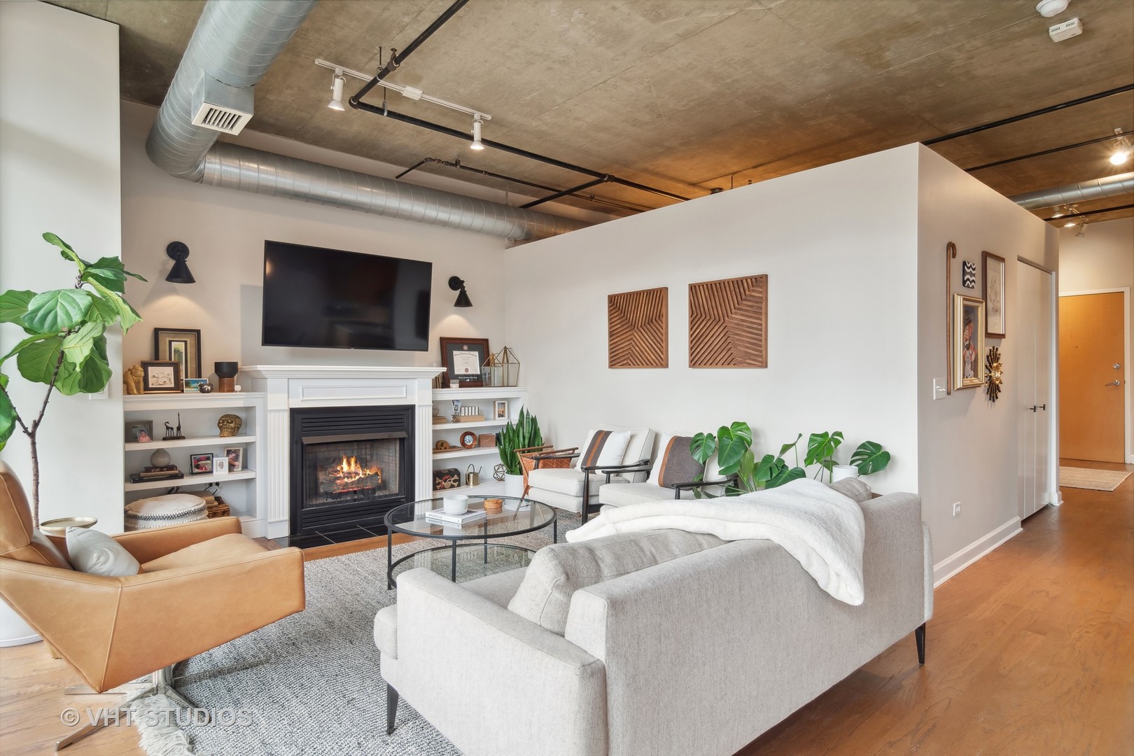 Undisclosed Address Chicago, IL 60607 - Photo 6 of 22 a living room with furniture a fireplace and a flat screen tv