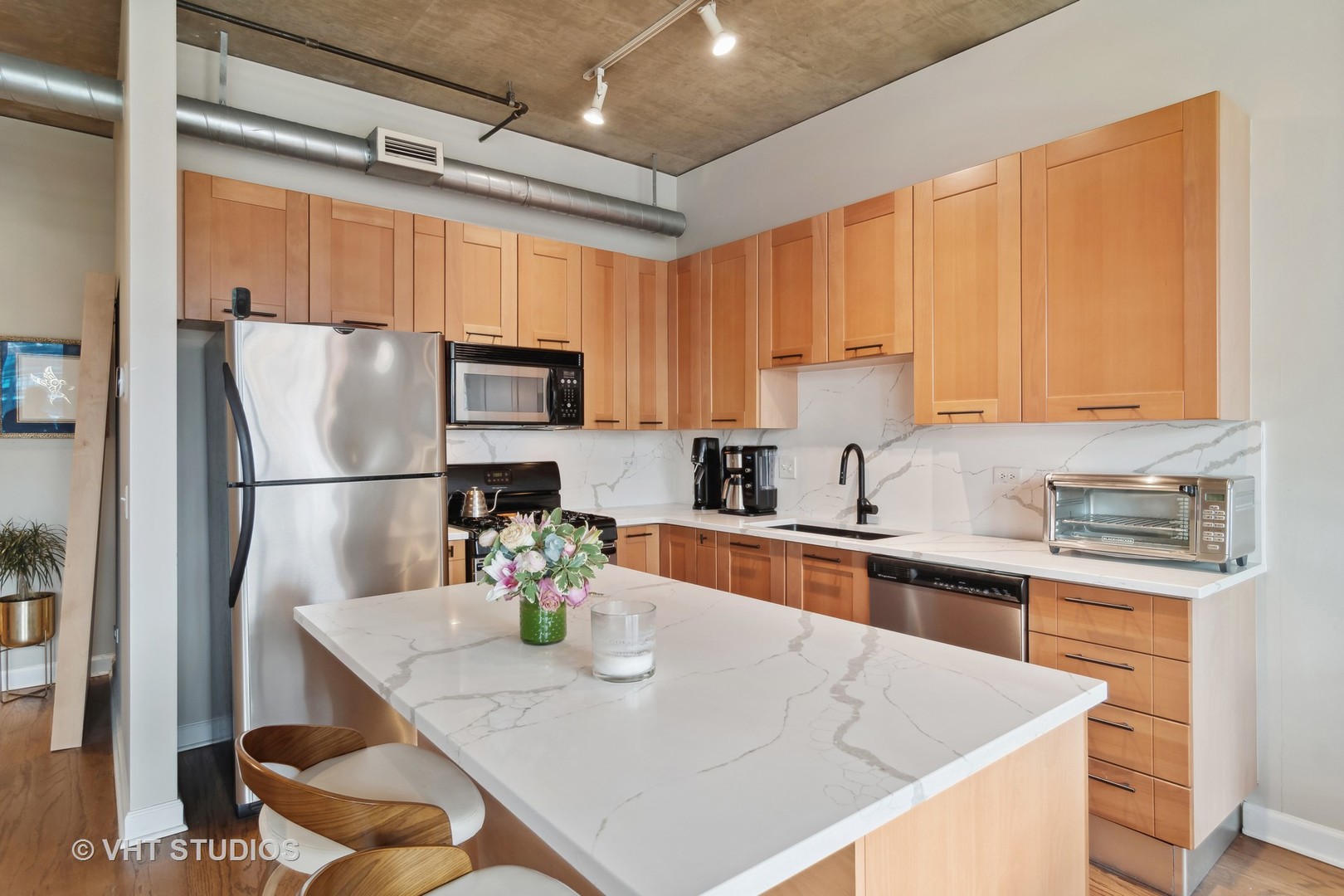 Undisclosed Address Chicago, IL 60607 - Photo 10 of 22 a kitchen with stainless steel appliances granite countertop a sink refrigerator and microwave