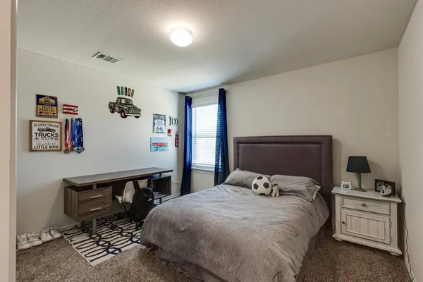 a bedroom with a bed and cabinets