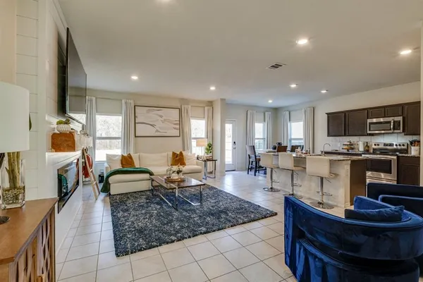 a living room with fireplace furniture and a flat screen tv