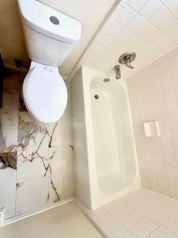 a bathroom with a toilet and shower