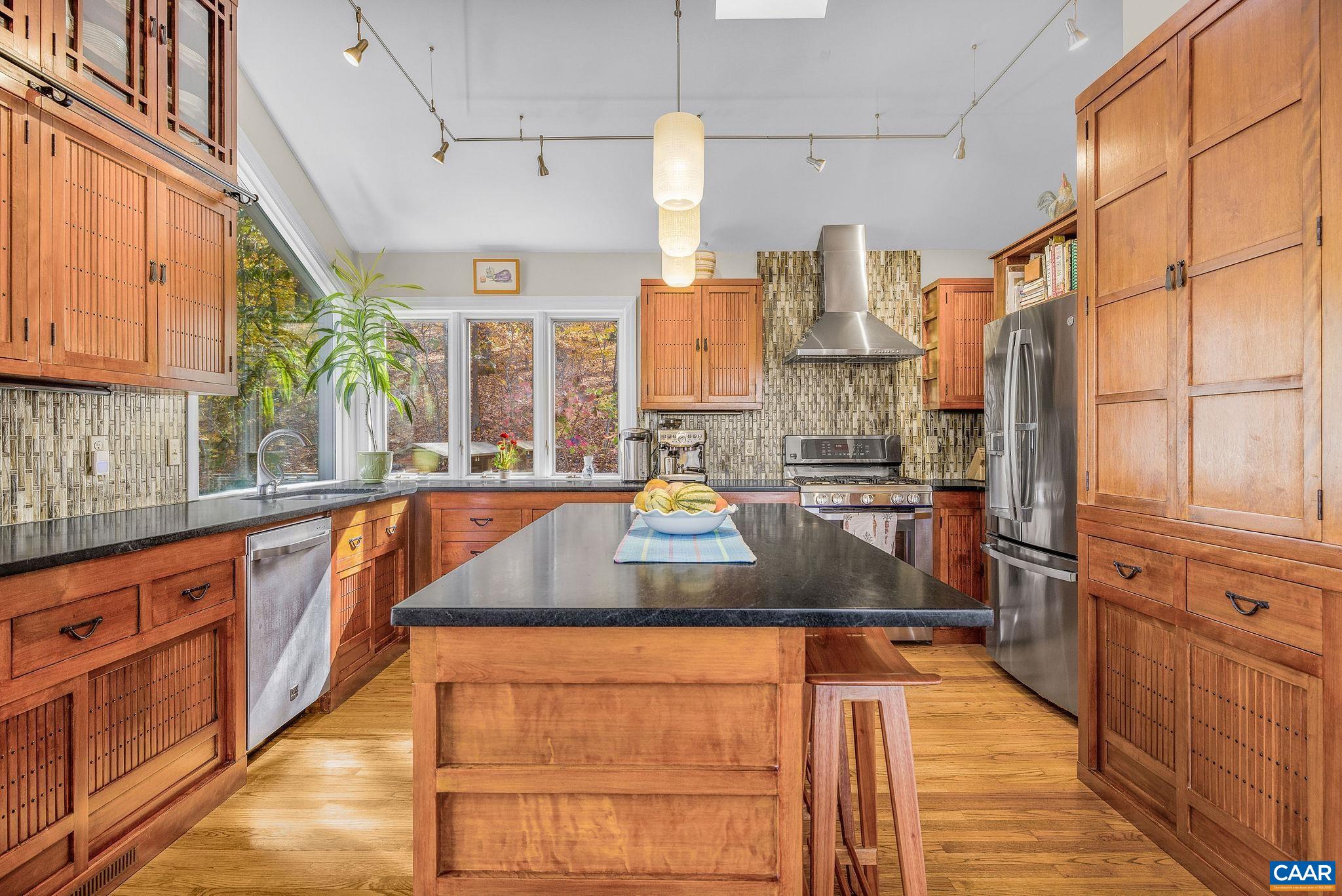 407 Broad Axe Road Charlottesville, VA 22903 - Photo 26 of 57 a kitchen with stainless steel appliances granite countertop a sink and cabinets