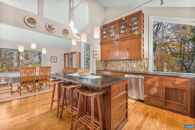 a living room with furniture a flat screen tv and a large window