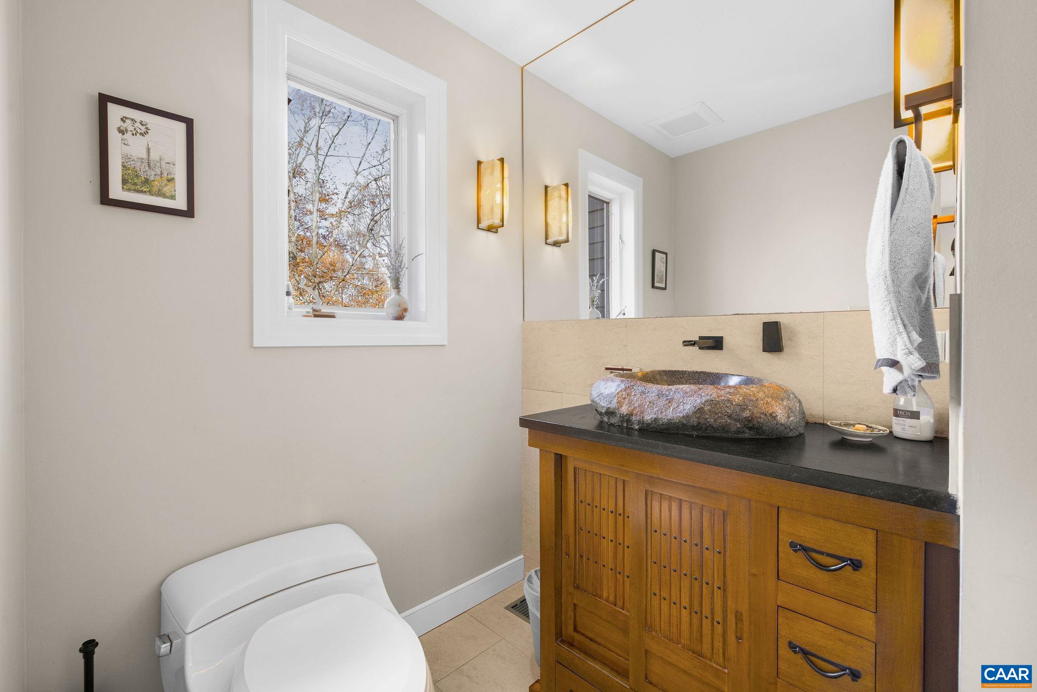 407 Broad Axe Road Charlottesville, VA 22903 - Photo 36 of 57 a bathroom with a granite countertop toilet sink and mirror