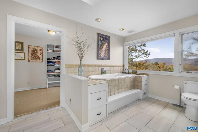 a spacious bedroom with a bed and a table in it