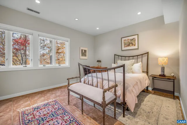 a living room with furniture a large window and a table