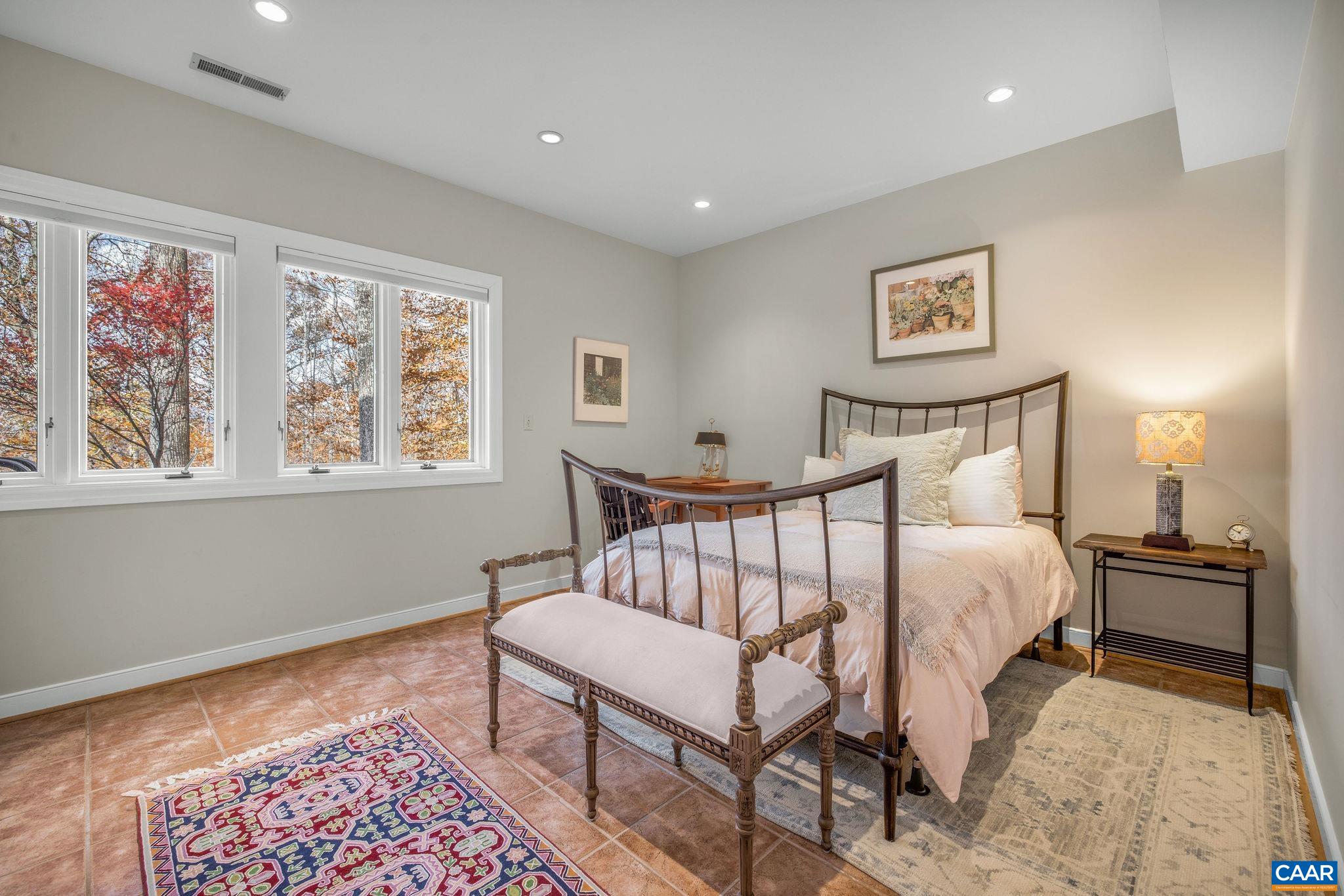 407 Broad Axe Road Charlottesville, VA 22903 - Photo 48 of 57 a bedroom with a bed and a painting on the wall
