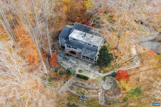 a view of a house with a yard covered in snow