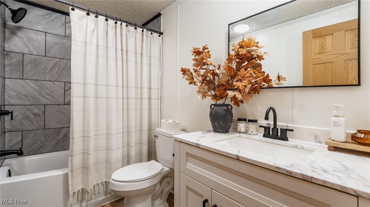 13306 Fairview Road Southeast Newark, OH 43056 - Photo 23 of 48 Bathroom featuring a textured ceiling, shower / tub combo with curtain, and vanity