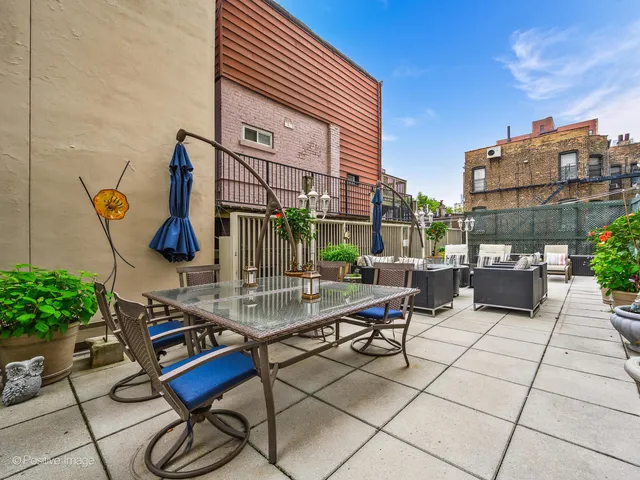 a view of an outdoor sitting area with couch and chairs