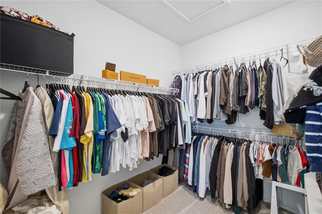 13816 Sharp Hawk Drive Riverview, FL 33569 - Photo 43 of 76 a view of walk in closet with clothes and shoes
