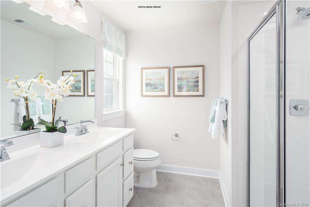 7120 Messina Road, Unit 135 Indian Land, SC 29707 - Photo 6 of 10 a bathroom with a toilet a sink and a mirror