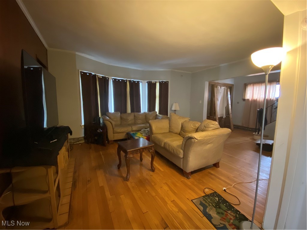 1380 Ansel Road Cleveland, OH 44106 - Photo 3 of 21 Living room with crown molding, a healthy amount of sunlight, and hardwood flooring