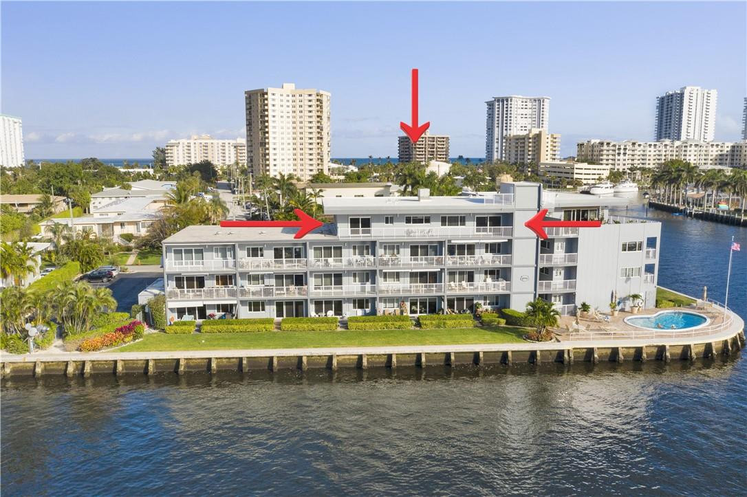 1201 South Riverside Drive, Unit PHB Pompano Beach, FL 33062 - Photo 1 of 33 a front view of building with yard and lake view