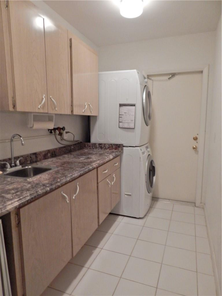 1201 South Riverside Drive, Unit PHB Pompano Beach, FL 33062 - Photo 20 of 33 a kitchen with a sink a stove and cabinets