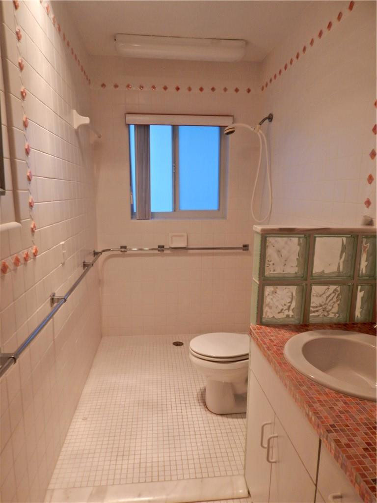 1201 South Riverside Drive, Unit PHB Pompano Beach, FL 33062 - Photo 21 of 33 a bathroom with a granite countertop toilet sink and mirror