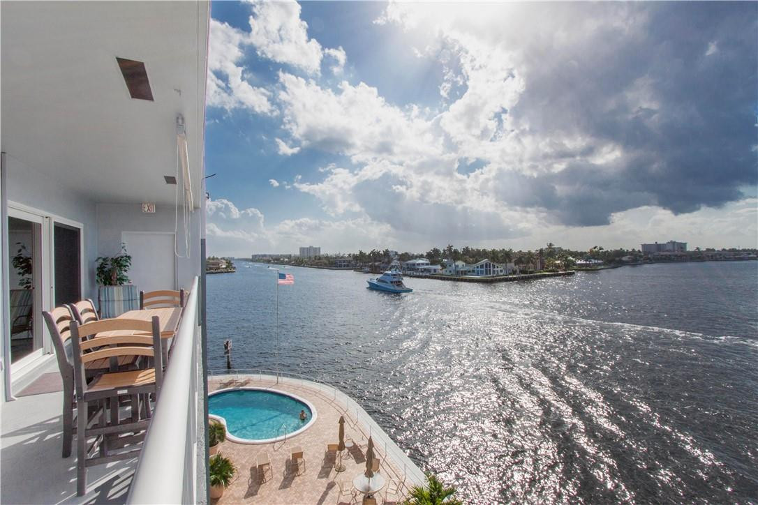 1201 South Riverside Drive, Unit PHB Pompano Beach, FL 33062 - Photo 26 of 33 a backyard of a house with table and chairs