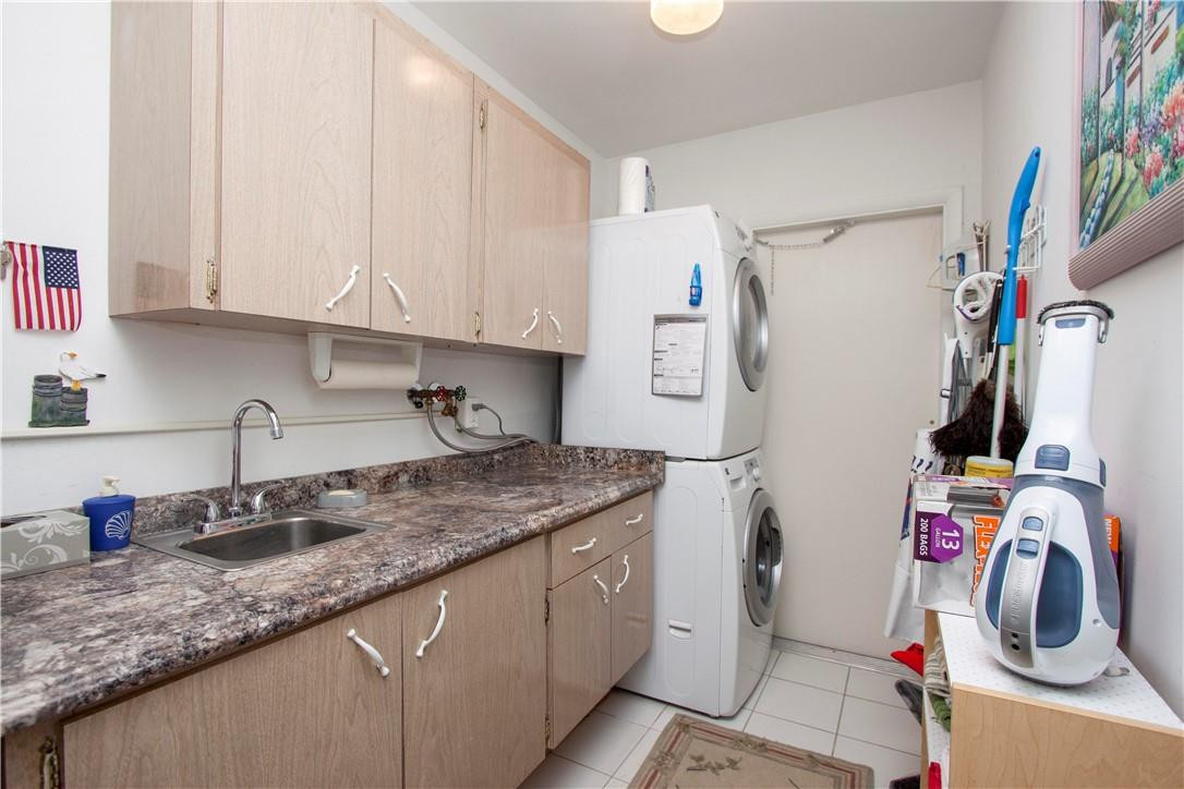1201 South Riverside Drive, Unit PHB Pompano Beach, FL 33062 - Photo 28 of 33 a kitchen with granite countertop a sink a stove and cabinets