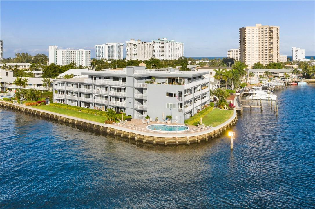 1201 South Riverside Drive, Unit PHB Pompano Beach, FL 33062 - Photo 29 of 33 a view of a swimming pool with chairs
