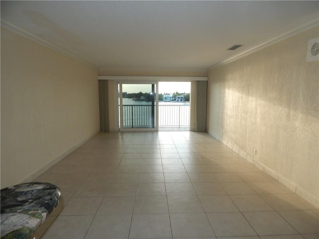 1201 South Riverside Drive, Unit PHB Pompano Beach, FL 33062 - Photo 7 of 33 a view of empty room with wooden floor and fan