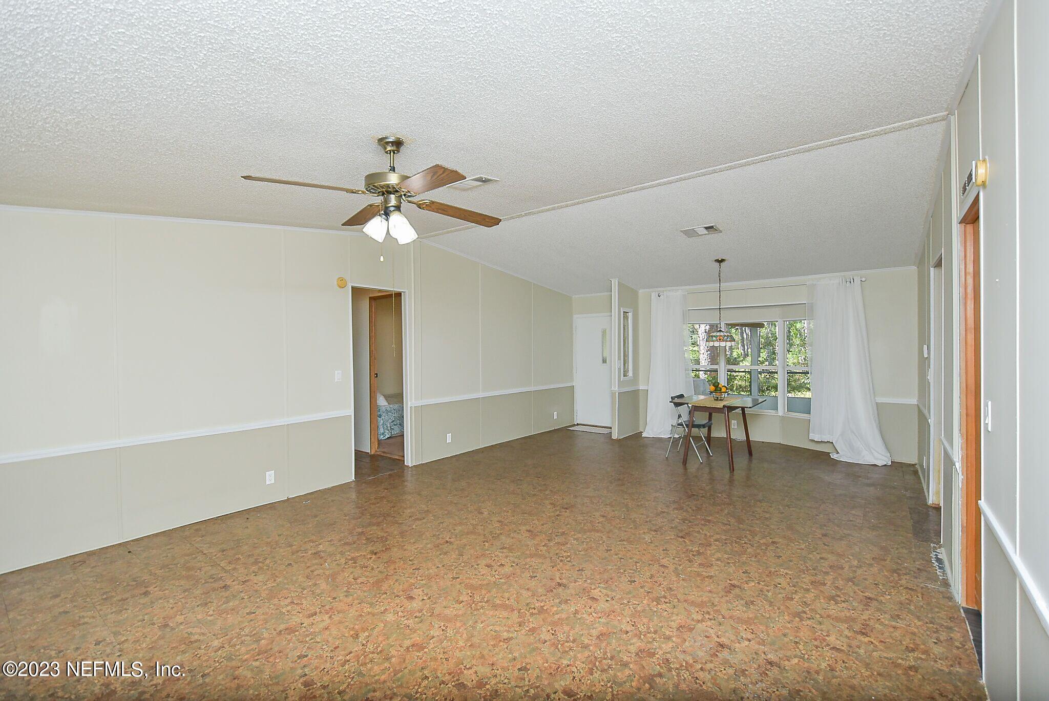 136 Lawrence Lane Georgetown, FL 32139 - Photo 8 of 33 wooden floor in an empty room with a window