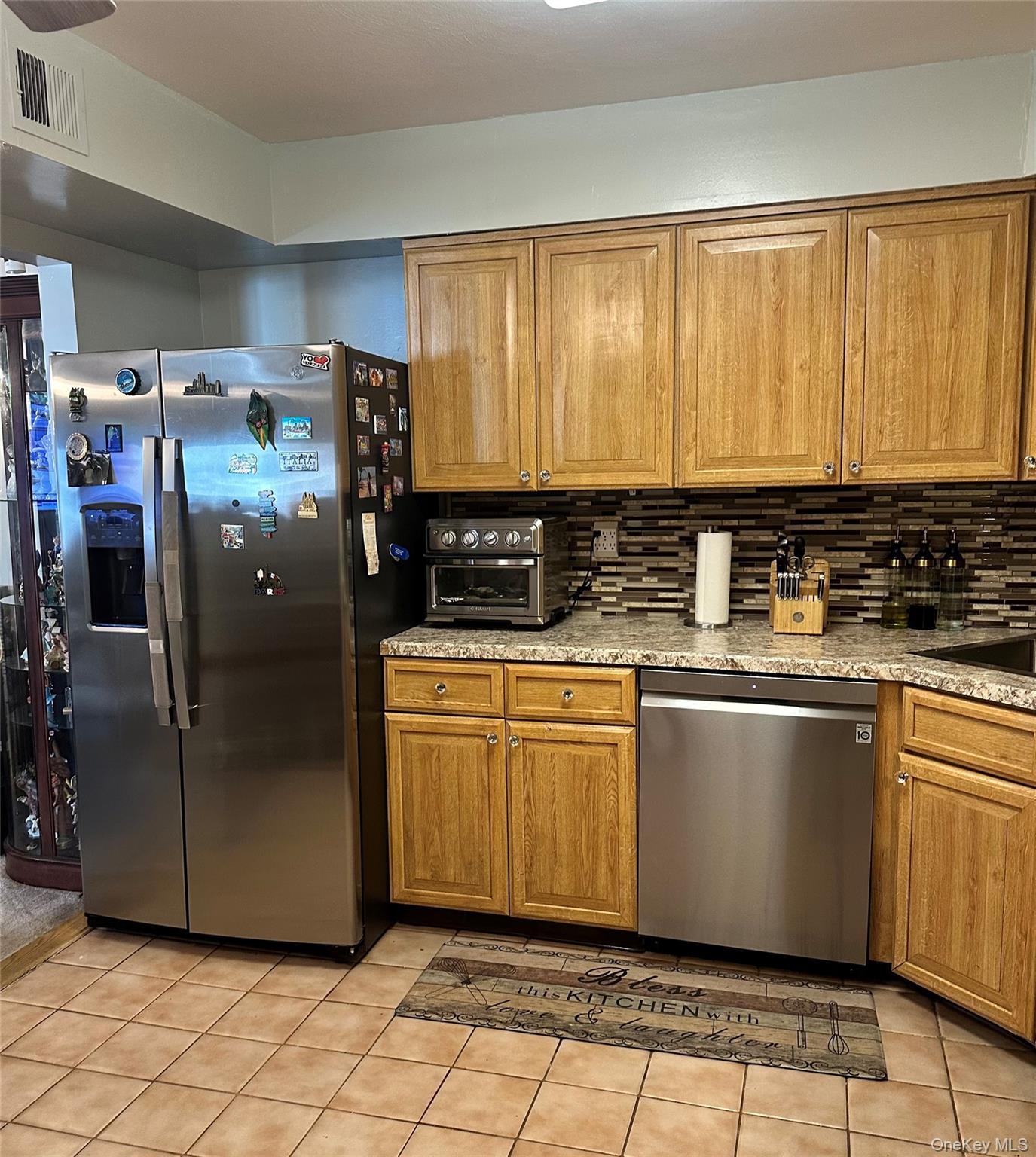 124 Santa Barbara Drive Plainview, NY 11803 - Photo 12 of 24 a kitchen with stainless steel appliances granite countertop a refrigerator a sink a stove a washer dryer and a cabinets