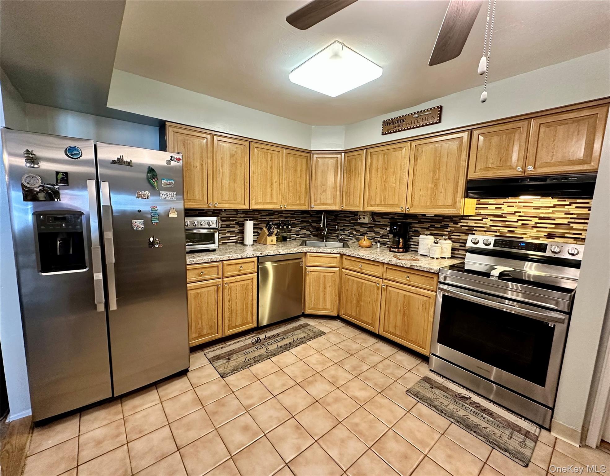 124 Santa Barbara Drive Plainview, NY 11803 - Photo 13 of 24 a kitchen with stainless steel appliances granite countertop a stove a sink and a refrigerator
