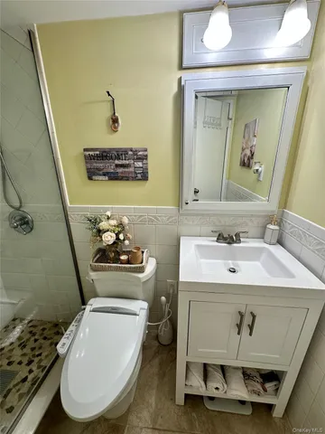 a bathroom with a sink toilet and mirror