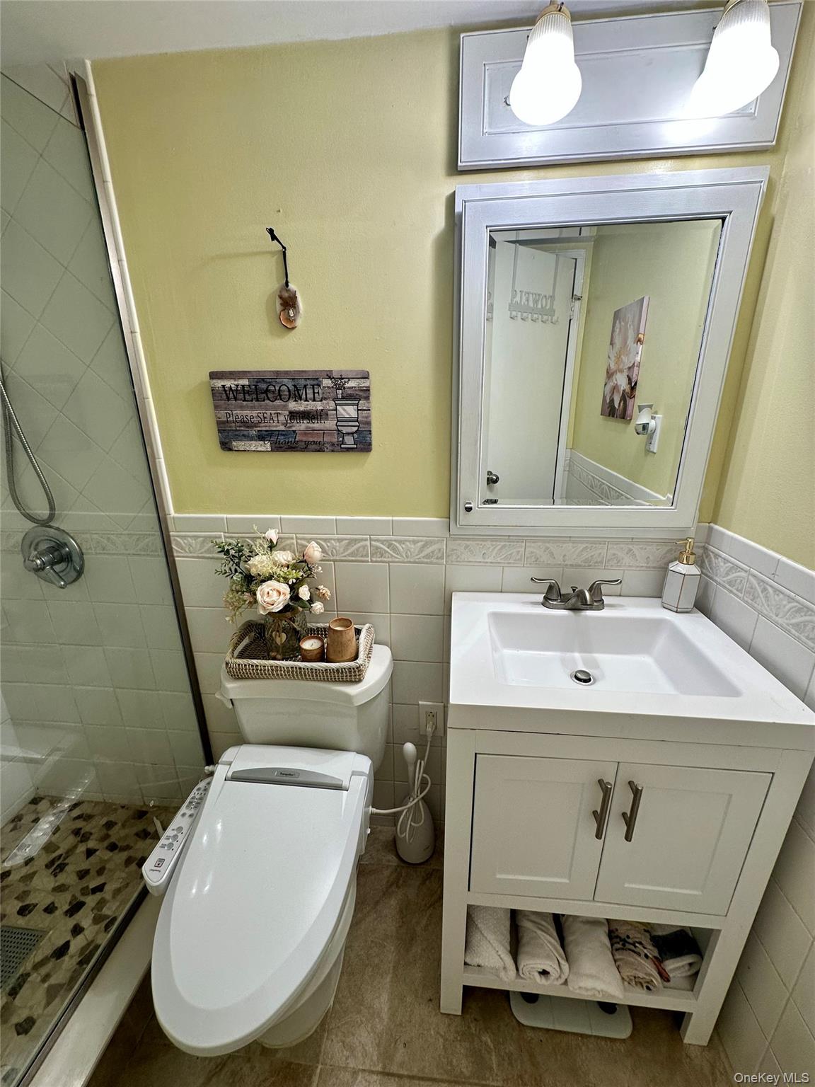 124 Santa Barbara Drive Plainview, NY 11803 - Photo 16 of 24 a bathroom with a sink toilet and mirror