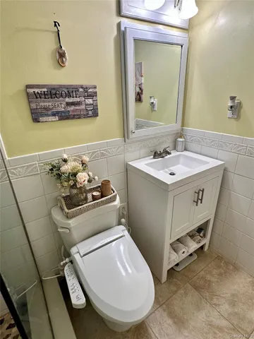 a bathroom with a sink toilet and mirror
