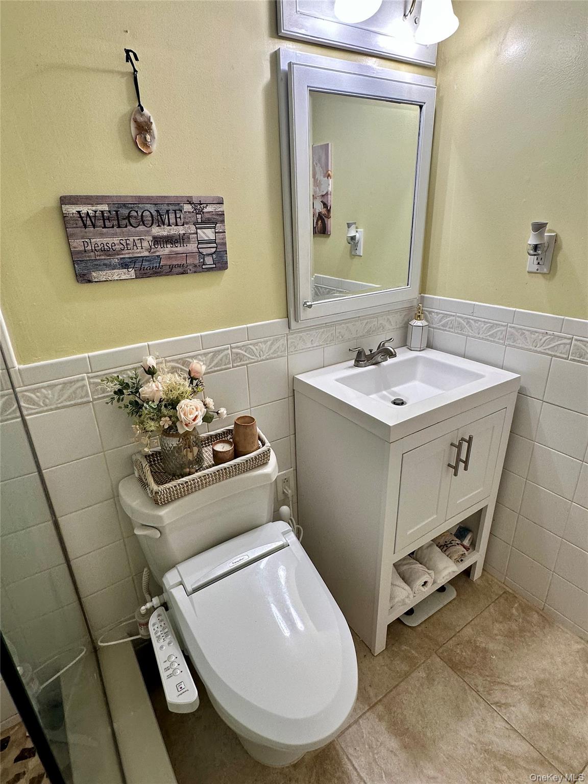 124 Santa Barbara Drive Plainview, NY 11803 - Photo 19 of 24 a bathroom with a sink toilet and mirror