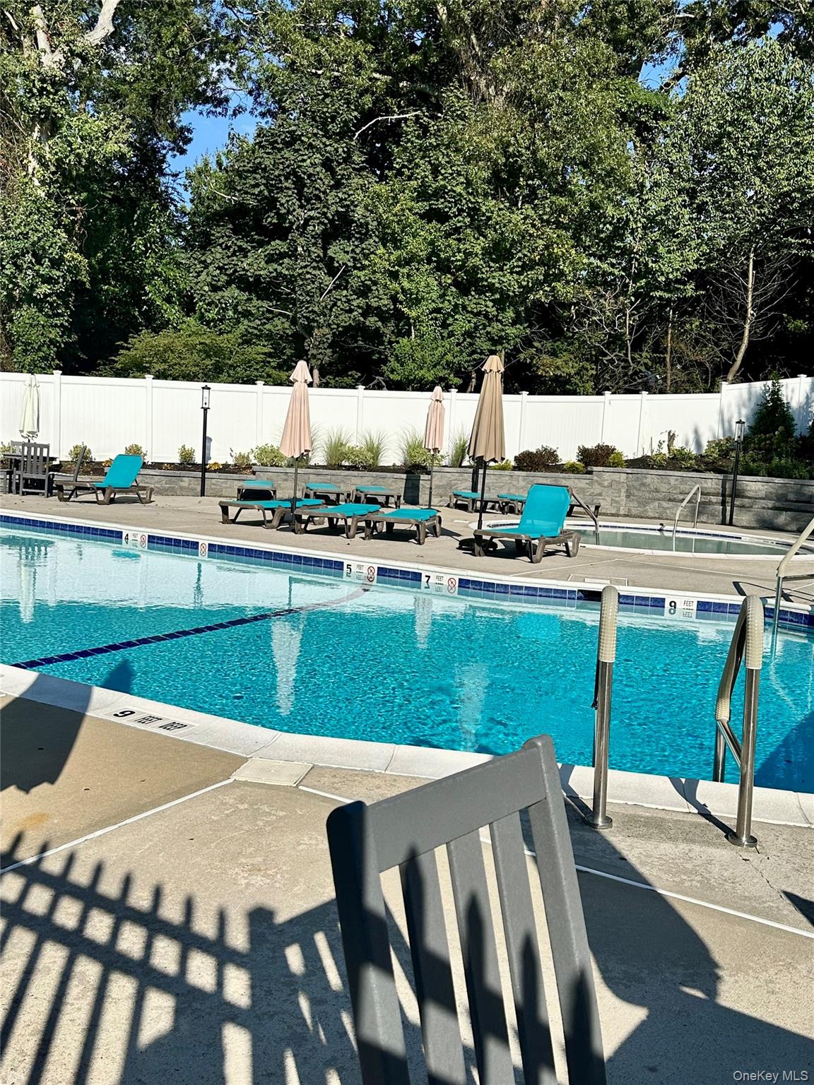 124 Santa Barbara Drive Plainview, NY 11803 - Photo 20 of 24 a view of a swimming pool with a patio