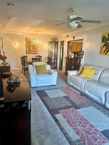a living room with furniture rug and a chandelier