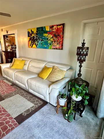 a living room with furniture and flowers