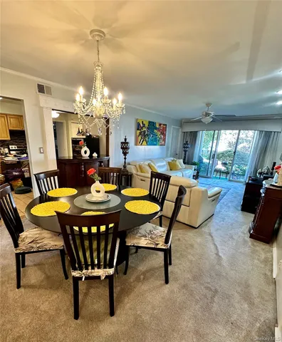 a dining room with furniture a rug and a chandelier