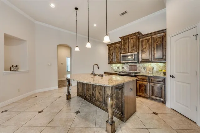 a kitchen with stainless steel appliances granite countertop a sink and stove