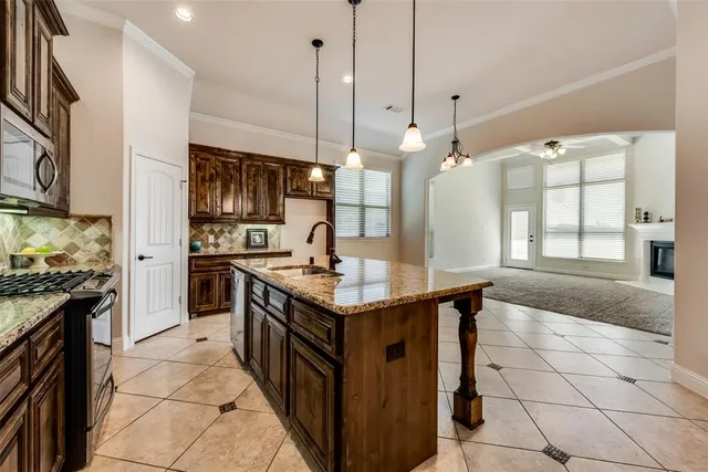 a view of a backyard with table and chairs and wooden fence