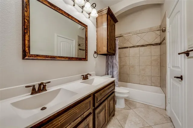 a bathroom with a tub a sink and a mirror