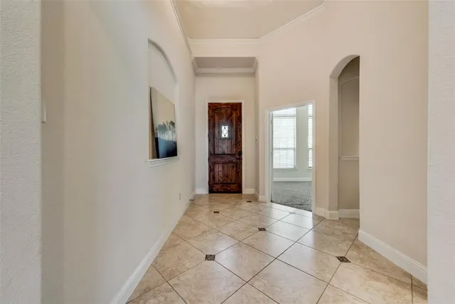 a view of a hallway with wooden floor and a bathroom