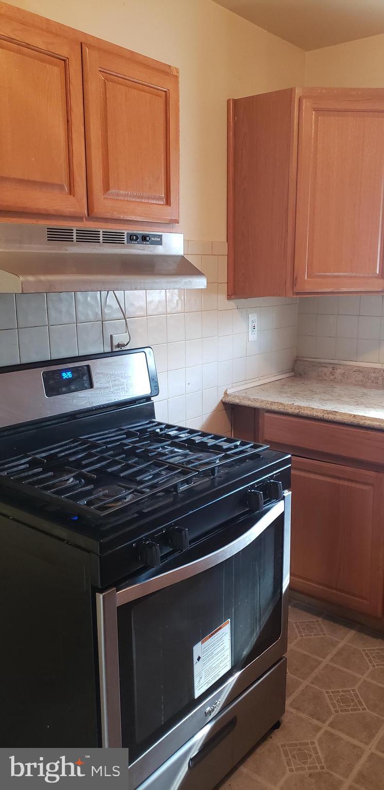 7744 Bender Road Landover, MD 20785 - Photo 3 of 11 a stove top oven sitting inside of a kitchen