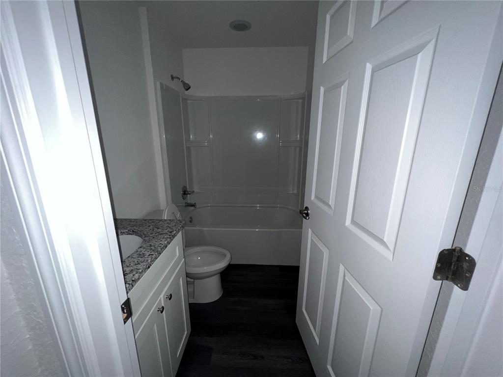 9 Maple Lane Ocklawaha, FL 32179 - Photo 12 of 26 a bathroom with a granite countertop sink toilet and shower