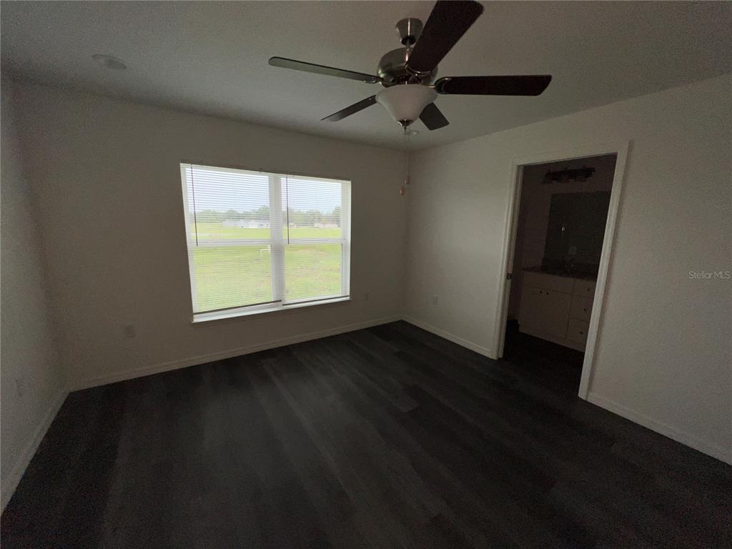9 Maple Lane Ocklawaha, FL 32179 - Photo 21 of 26 a view of an empty room with wooden floor and a window