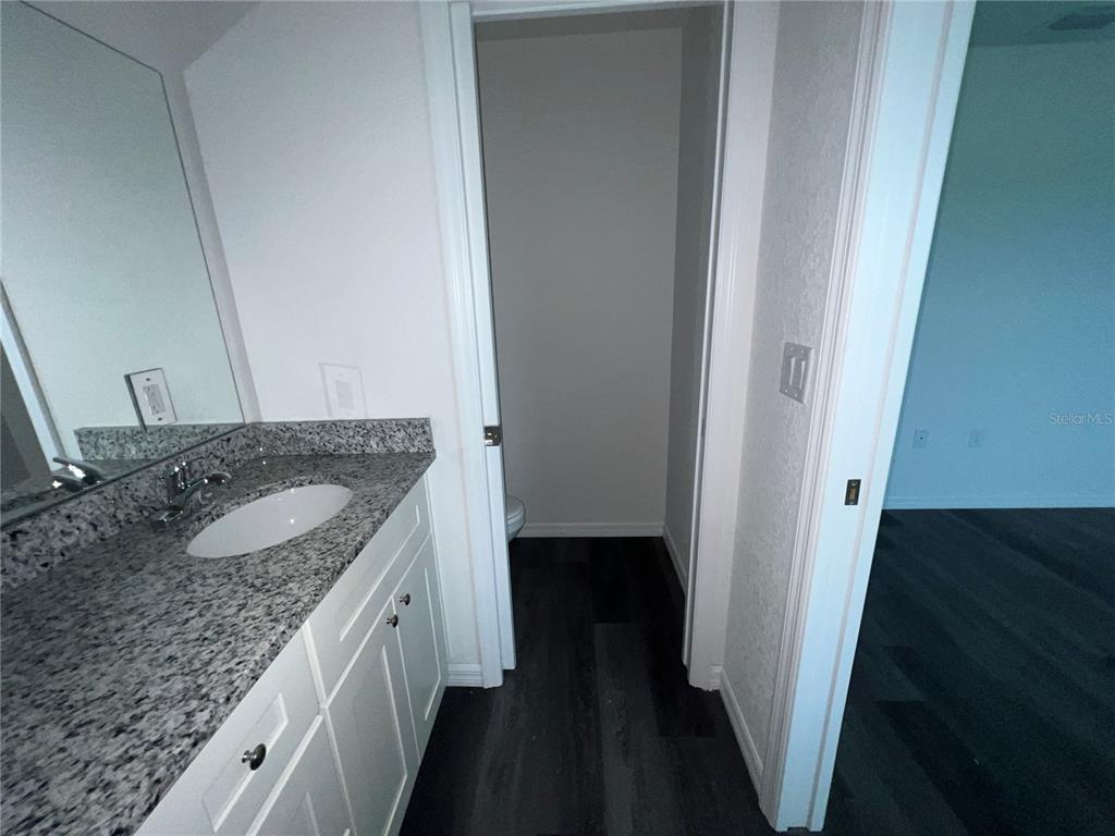 9 Maple Lane Ocklawaha, FL 32179 - Photo 24 of 26 a bathroom with a granite countertop sink and a mirror