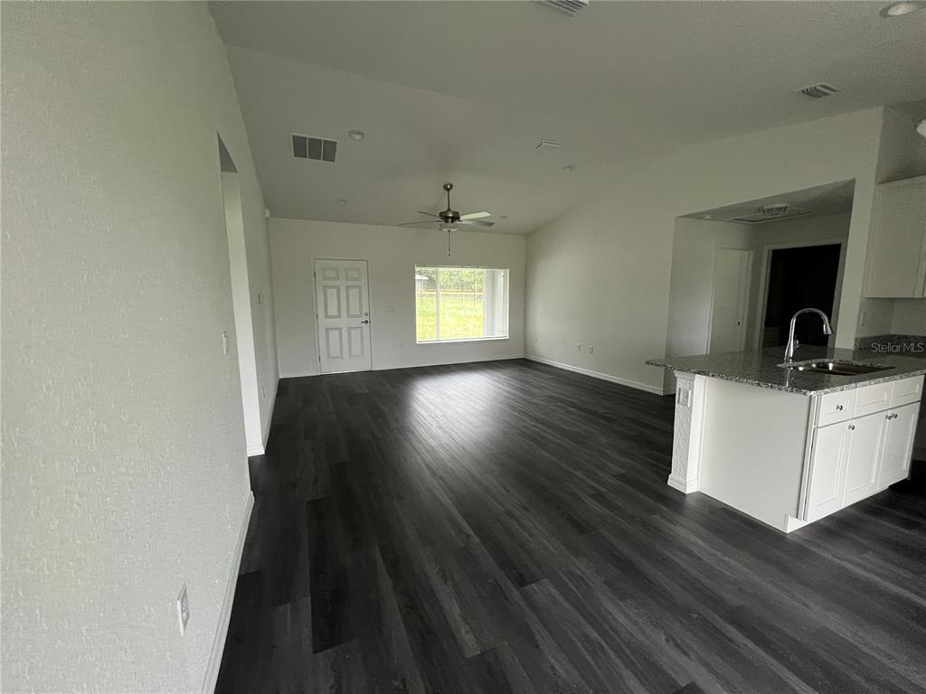 9 Maple Lane Ocklawaha, FL 32179 - Photo 6 of 26 wooden floor in an empty room with a window