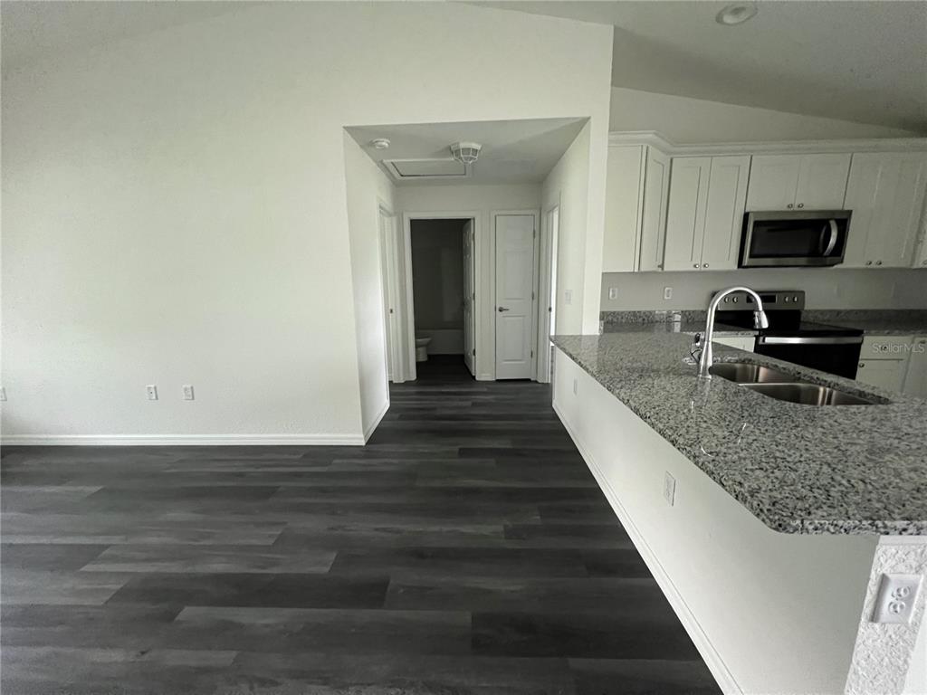 9 Maple Lane Ocklawaha, FL 32179 - Photo 8 of 26 a view of a kitchen with sink and wooden floor