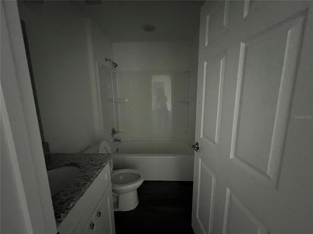 9 Maple Lane Ocklawaha, FL 32179 - Photo 10 of 26 a bathroom with a granite countertop toilet a sink and shower